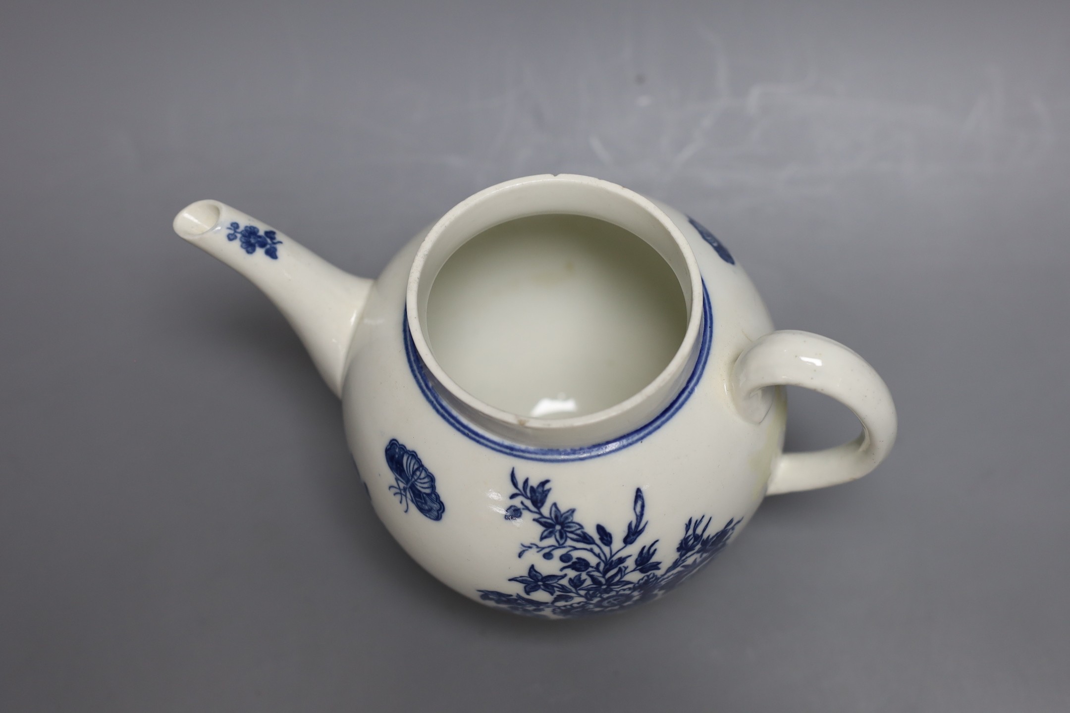 A Caughley teapot and cover printed in underglaze blue with the Three Flowers pattern, S mark in blue to base, 17 cms high